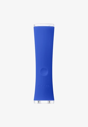 Blue silicone product with a smooth texture, tapered shape, and transparent top. Marked with "FOREO" near the base.