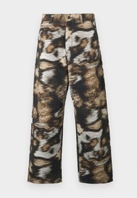 Wide-leg trousers featuring a bold, abstract pattern in black, brown, and cream hues. Made from textured fabric with a high waist.