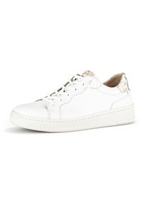White leather sneaker with a textured beige heel accent, featuring a rounded toe, laces, and a stitched sole.