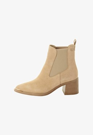 Beige suede ankle boots with elastic side panels, square toe, and a block heel. A pull tab is present at the back for easy wear.