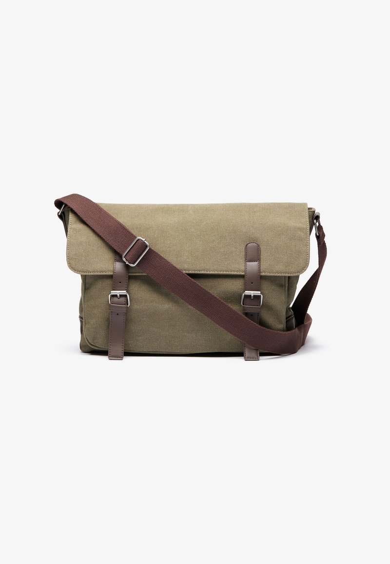 Green canvas messenger bag with brown leather accents, adjustable strap, and silver hardware. Flap closure with buckle details.