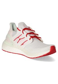 Baskets en maille blanche avec lacets rouges, semelle rouge, semelle intermédiaire blanche texturée et cage de maintien latérale translucide.