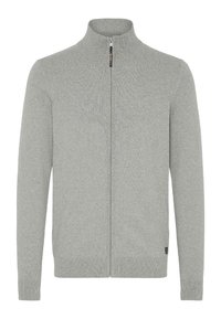 Sudadera gris con cremallera y cuello alto, puños y dobladillo acanalados. Textura de punto suave y diseño minimalista. Presenta un logo en el pecho.