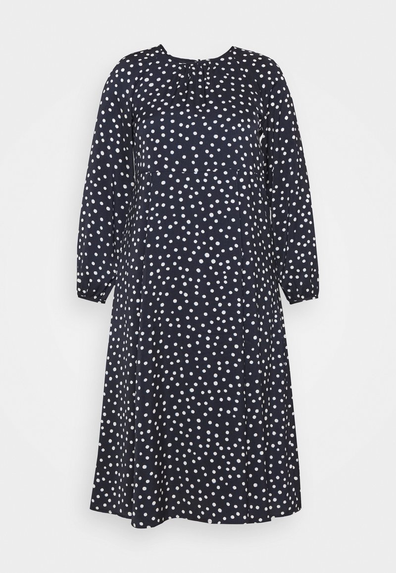 Navy-Kleid mit langen Ärmeln, Rundhalsausschnitt und Raffung. Hat weiße Punkte und eine fließende A-Linie. Weicher Stoff.