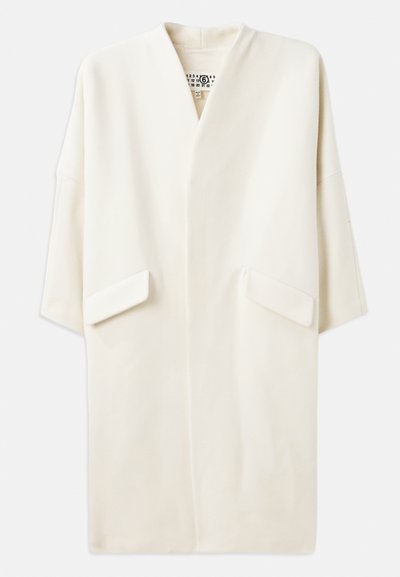Cream-colored mid-length coat with a relaxed fit, kimono-style sleeves, and two front pockets. Soft, smooth fabric, minimalistic design.