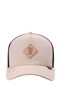 Beige színű baseballsapka fekete hálós hátsó résszel, ívelt vécsel és a középen található, rombusz alakú bőrpáccal, amelyen a "DJINNS" logó látható.