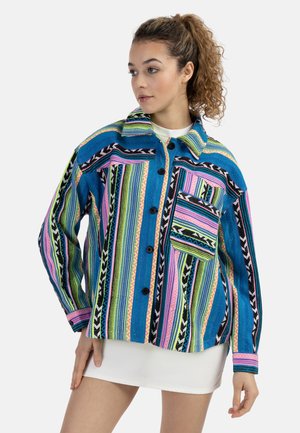 Colorful woven jacket featuring vertical stripes in blue, pink, green, and black, with a collar, buttons, and a patch pocket.