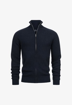 Navyblauer gerippter Strick-Zipfelpullover mit hochgeschnittenem Kragen, ausgestattet mit einem silbernen Reißverschluss und enganliegendem Bündchen. Weiche Textur mit tailliertem Design.
