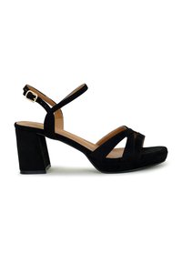Black suede high-heeled sandals featuring a block heel, crossed straps, an adjustable ankle strap with a gold buckle, and a textured finish.