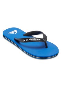 Sininen flip-flop, jossa on teksturoitu pohja, mustat kumivarskyttää ja valkoinen Quiksilver-logo. Ominaisuuksiin kuuluu kontrastinen valkoinen ja musta reuna.