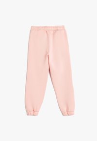 Lichtroze sweatpants met een elastische tailleband en opgerolde enkels, gemaakt van een zachte, gestructureerde stof. Geen zichtbare patronen of hardware.