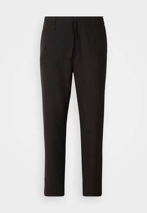 Black jogger pants made of smooth fabric. Feature an elastic waistband with a drawstring, tapered legs, and no visible pockets. Simple design.