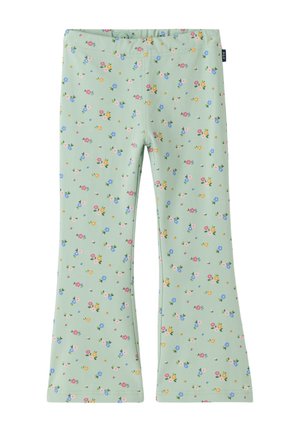Hellgrüne Kinderleggings mit ausgestelltem Bein und kleinem, buntem Blumenmuster über den gesamten Stoff.