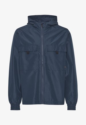 Navy blue lightweight rain jacket with a hood, featuring two chest pockets, elastic cuffs, and a front zipper. Smooth, water-resistant fabric.