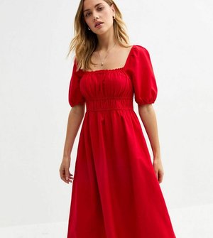 Red midi dress with puff sleeves, square neckline, and gathered waist. Smooth fabric with a loose fit, reaching mid-calf length.