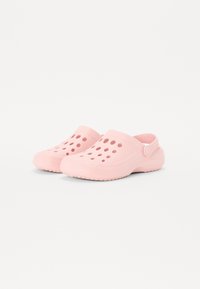 Pink clogs made of lightweight material featuring perforations, a back strap, and textured soles for grip and comfort.