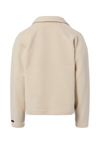 Beige Fleecejacke mit weicher Textur, Kragen und langen Ärmeln. Verfügt über einen kurzen Schnitt und ein kleines schwarzes Logo auf dem Ärmel.