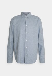 Camicia a maniche lunghe azzurro chiaro realizzata in tessuto testurizzato. Presenta un colletto a punta e una patta frontale con bottoni visibili.