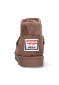 Bruine suède enkelboot met een zachte binnenvoering, voorzien van een vlakke rubberen zool en een prominente Vingino logo label op de achterkant.