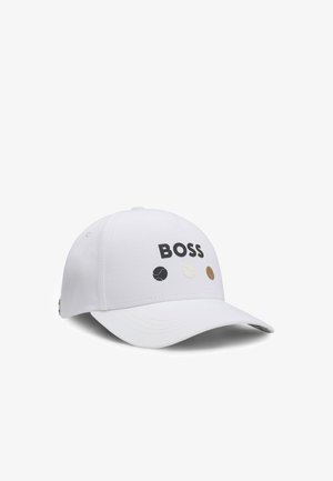 White baseball cap with a curved brim, featuring "BOSS" logo in black and three small colored tennis ball designs in varied shades.