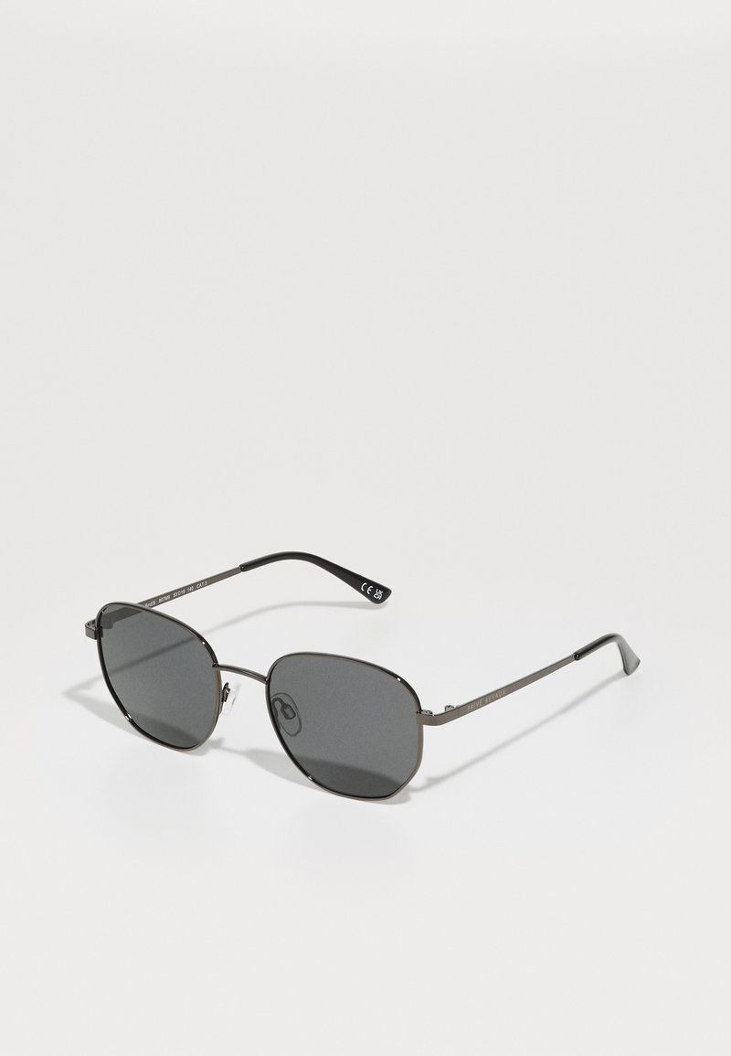Óculos de sol ovais com lentes escuras e armações finas em metal cinza. Apresenta almofadas nasais ajustáveis e templos esbeltos com detalhe de marca.