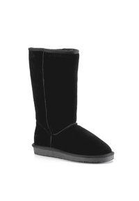 Black suede knee-high boot with a flat rubber sole, soft lining, and minimal stitching detail along the seams.