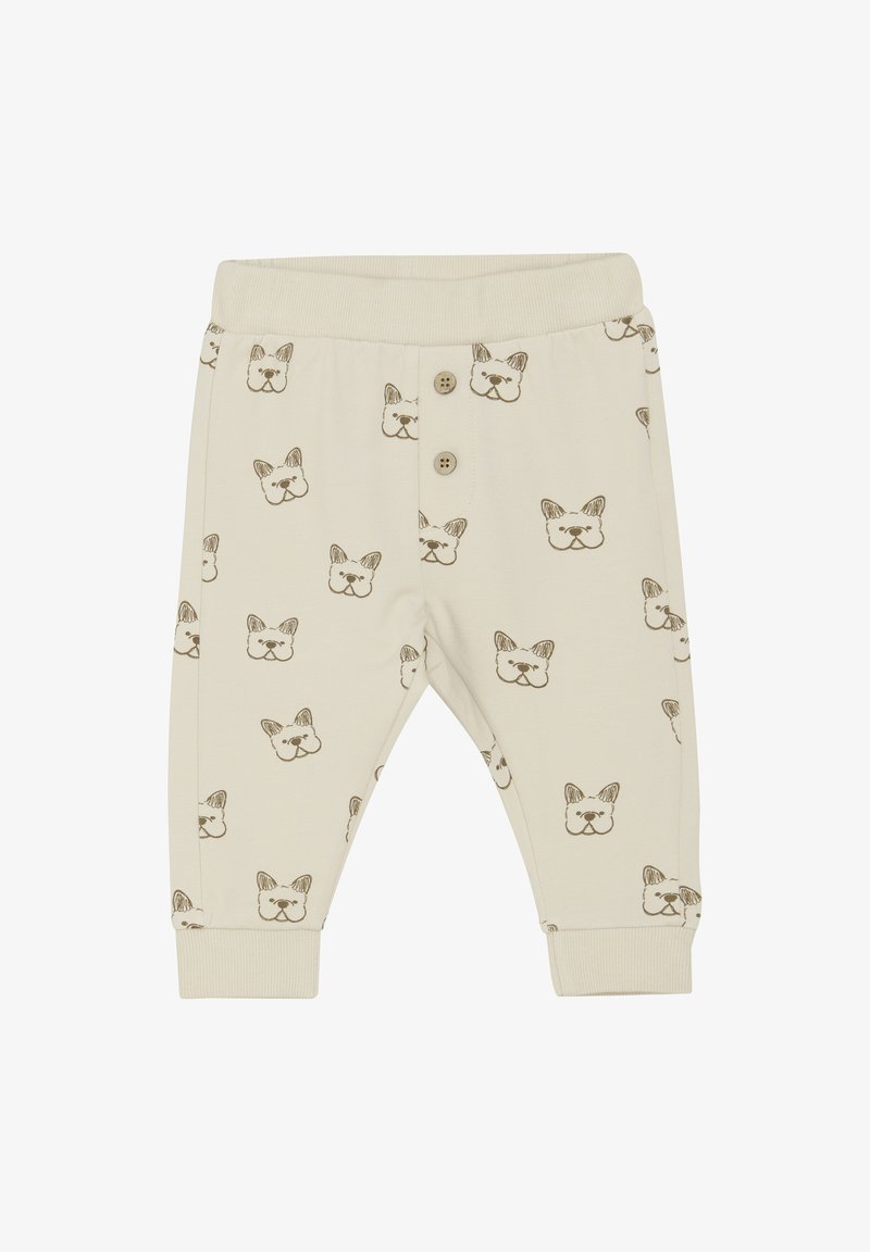 Pantalons en coton beige clair ornés de visages de bouledogue français imprimés en marron. Présente une taille et des poignets côtelés, ainsi que deux boutons décoratifs.