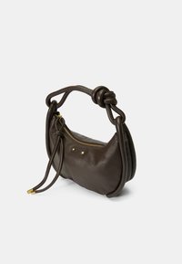 Brown leather handbag with a curved shape, knotted handle, and gold-tone zipper. Features textured material and minimal hardware accents.