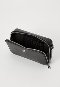 Black textured bag with a rectangular shape, zip closure, and an interior featuring card slots and a smooth lining. Silver hardware accents.
