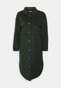 Green, wool-blend long shirt coat with a button-down front, two chest pockets, and a curved hem. Features a classic collar and button accents.