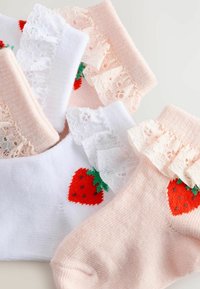 Fyra par strumpor: två rosa och två vita med spetsdetaljer, var och en med broderade röda jordgubbar och gröna blad. Mjuk textur.