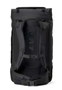 Black backpack with a roll-top design, padded shoulder straps, adjustable buckle, and logo detail. Made from durable, textured fabric.