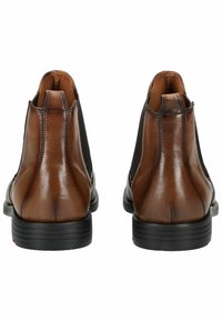Braune Leder-Ankle-Boots mit elastischen Seitenpaneelen, entworfen mit einer abgerundeten Zehenpartie und einer schwarzen Gummisohle. Mit Steppdetails ausgestattet.