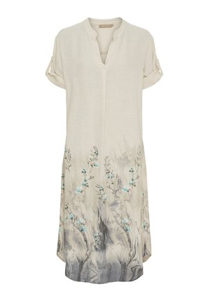 Linnedress med V-hals og rullede korte ærmer. Beige farve med blå blomstermotiver og et gradient gråt mønster ved kanten.