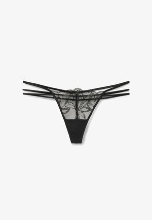 Lingerie noire avec un dos en dentelle à motifs floraux, un devant lisse et plusieurs fines lanières sur les côtés.