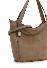 Tan leather shoulder bag with textured surface, braided detail along the seam, and a decorative metal tag attached.