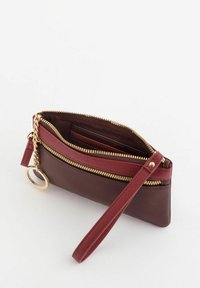Leather wristlet with dual zip pockets, maroon and dark brown color combination, gold-tone hardware, and a detachable wrist strap.
