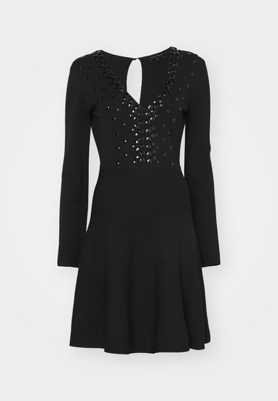 Black dress with long sleeves, fitted bodice adorned with black sequins, keyhole back detail, flared skirt, smooth texture.