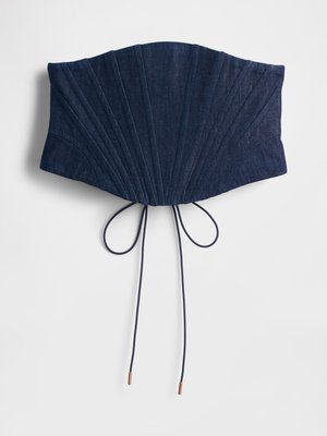 Navy blue denim corset with a pleated design, featuring ties with copper accents at the ends. Flat, structured shape.