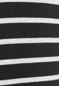Tessuto a maglia a righe orizzontali in bianco e nero con strisce alternate spesse e sottili.