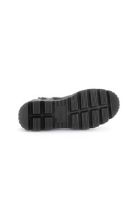 Black rubber shoe sole with textured tread pattern. Features grooves and circular accents, branded with "Gabor" on the bottom.