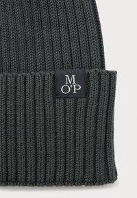 Dark gray ribbed knit beanie with folded cuff and a black square tag featuring white "M O'P" lettering.