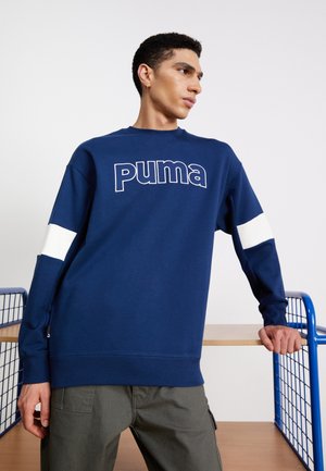 Navy sweatshirt with white accents and a prominent "Puma" logo. Features a crew neck, long sleeves, and ribbed hem. Soft, textured fabric.