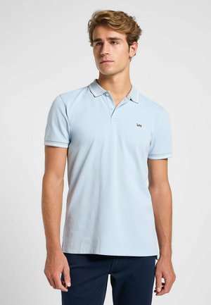 Light blue polo shirt made of soft cotton. Features a collar, short sleeves, and a small black logo on the left chest.
