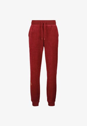 Pantalons de survêtement en velours rouge avec une taille élastique, un cordon de serrage, des poches latérales et des poignets côtelés. Présente un petit logo sur la jambe inférieure.