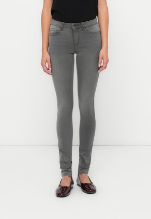 Gray skinny jeans with a high waistband, five-pocket design, and subtle stretch fabric, paired with glossy burgundy ballet flats.