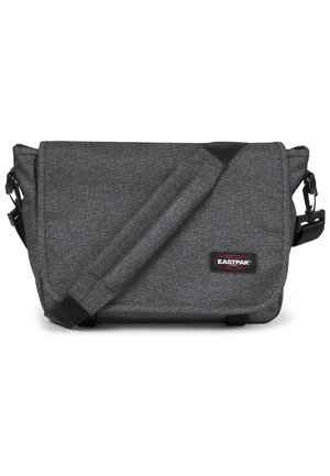Gray messenger bag with a textured fabric, adjustable strap, and a logo patch. Features a flap closure and a slim, rectangular shape.