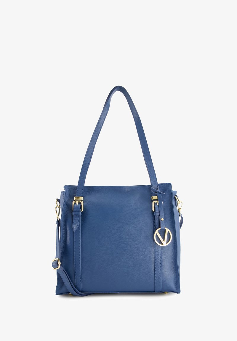 Blue leather handbag with a structured shape, dual handles, adjustable strap, and gold-tone circular logo accent. Smooth texture.