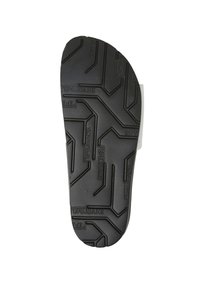 Semelle de chaussure en caoutchouc noir avec un motif de semelle texturé. Présente un logo en relief et des rainures pour une meilleure adhérence. Forme arrondie pour le confort.