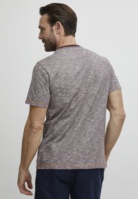 Short-sleeve, heathered T-shirt in light gray with orange accents at the collar and sleeves. Soft, textured fabric with a relaxed fit.